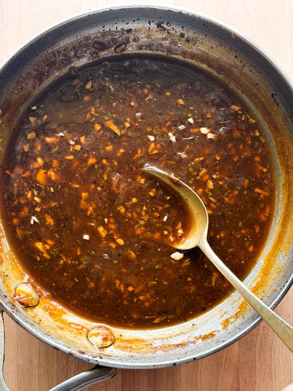 chicken sizzler sauce in a pan with spoon
