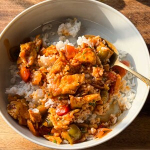 Spicy chilli egg stir fry served over white rice in a bowl.