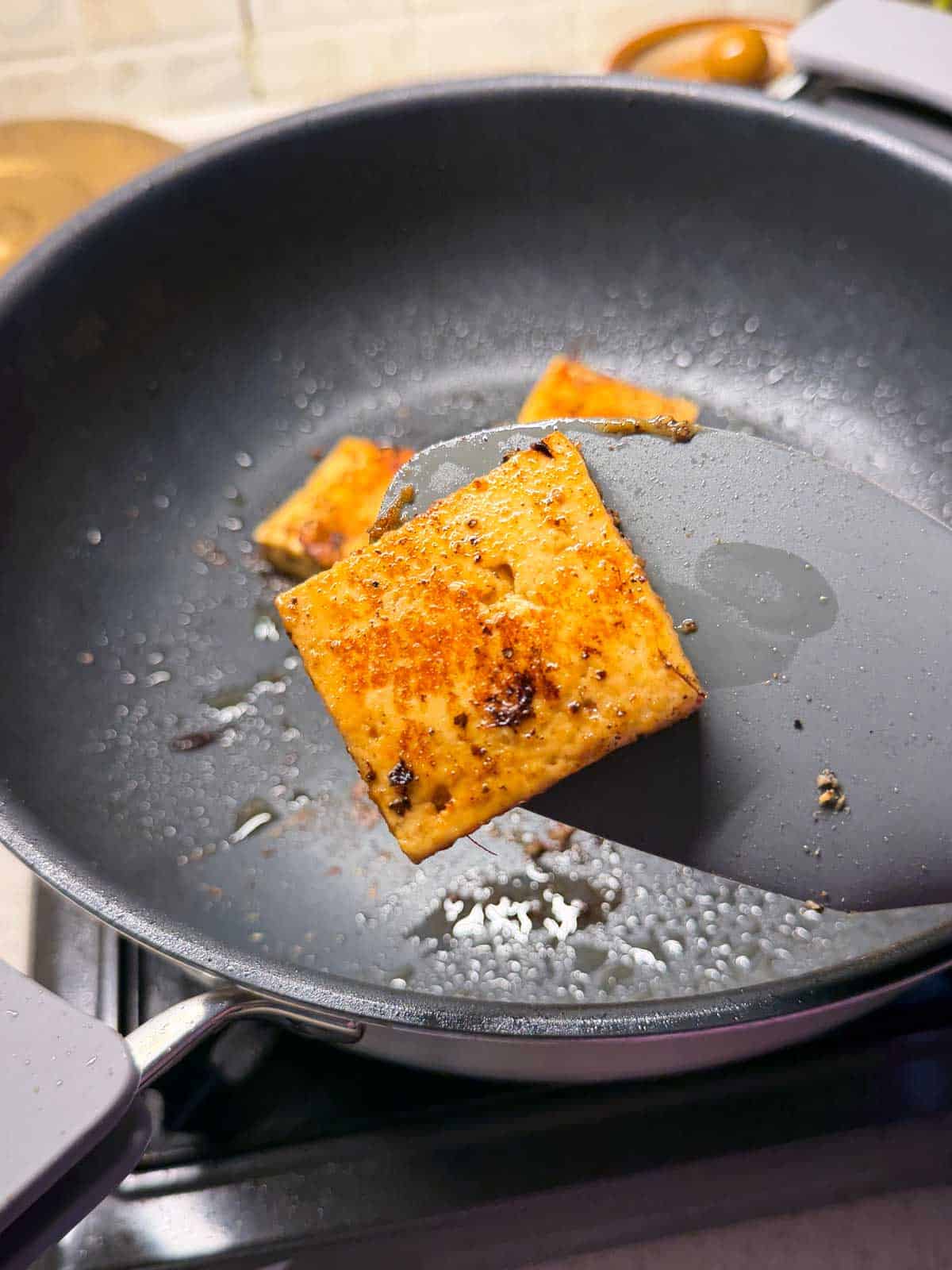 close up shot of sauteed paneer sauteed to showcase its color and texture