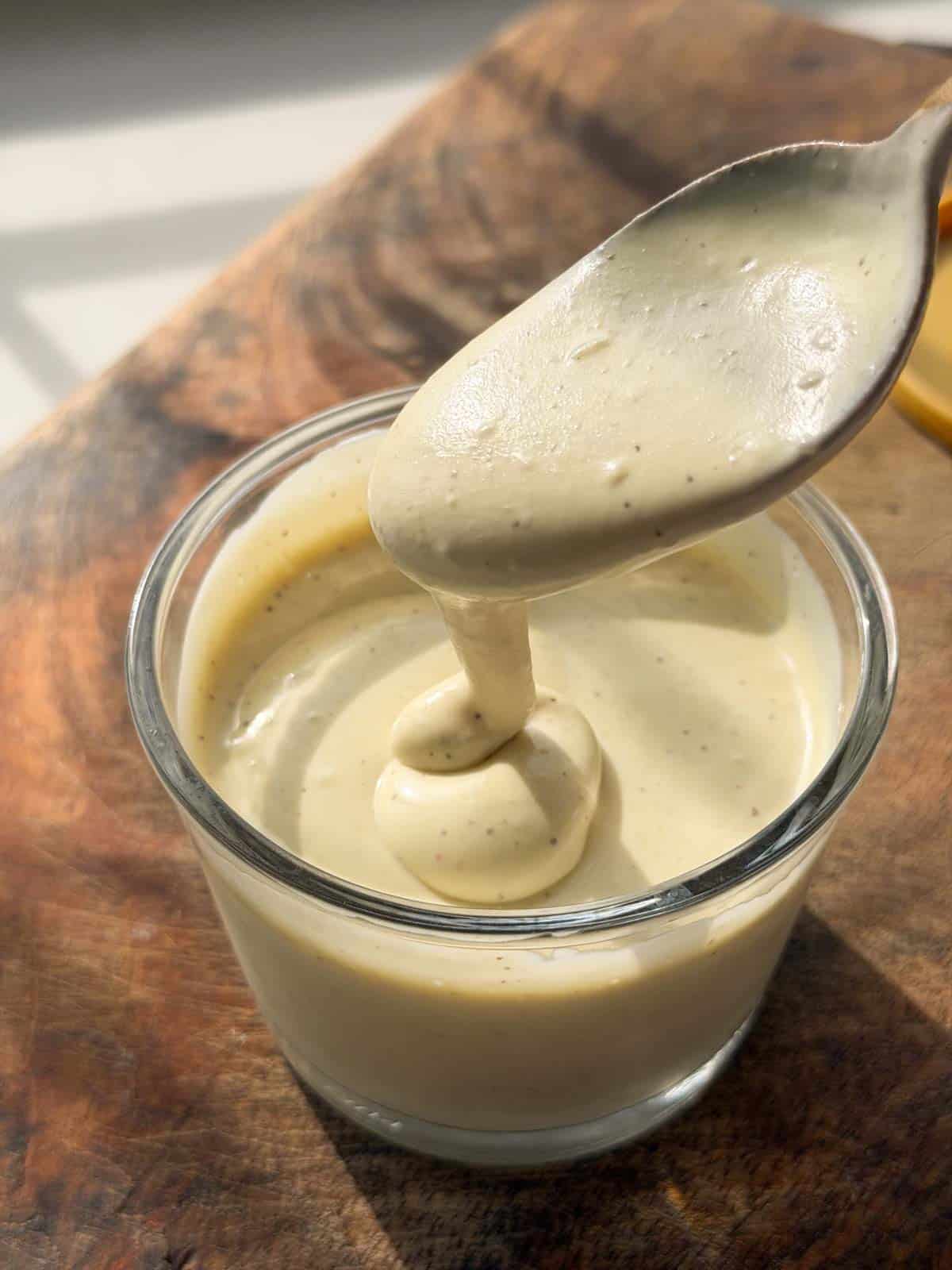 smooth and creamy veg mayo scooped up in a spoon