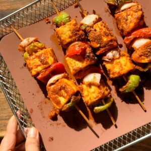 air fryer paneer tikka lined on an air fryer tray ready to be served