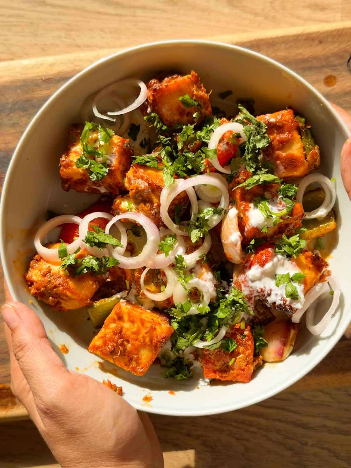 air fryer paneer tikka served in a whie bowl with accompaniments