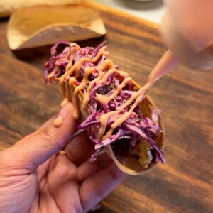 a person holding a Mexican paneer taco