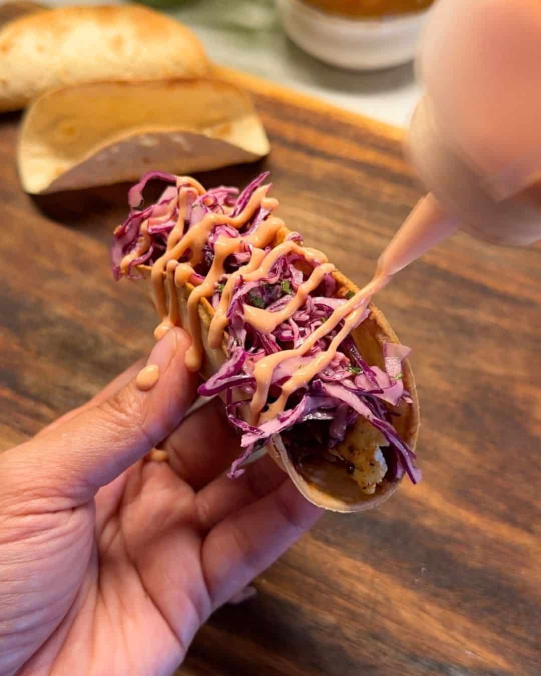 a person holding a Mexican paneer taco