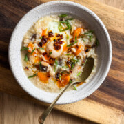 rice congee served in a bowl with toppings