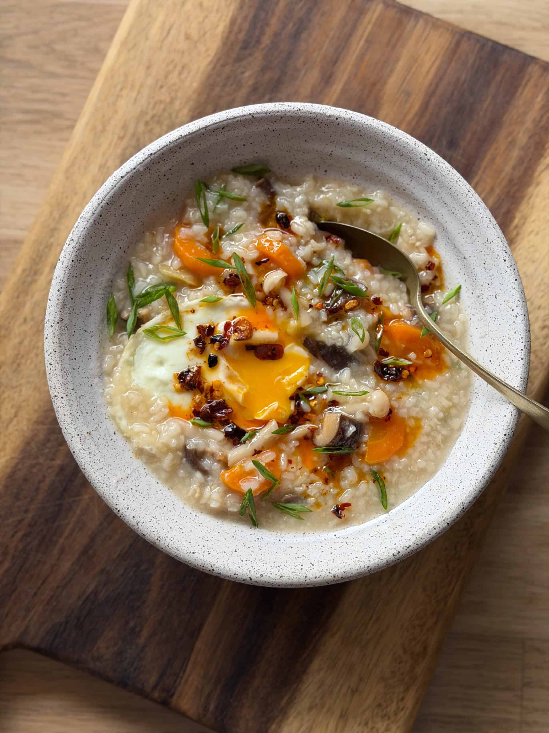 rice congee served in a bowl with toppings