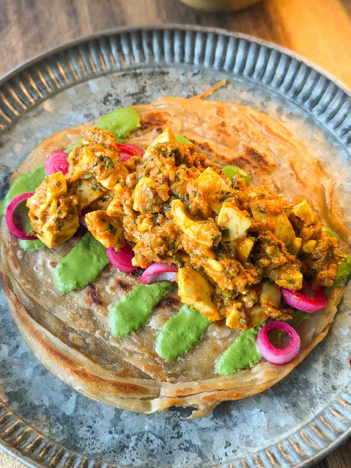 masala egg roll assembled on a plate ready to be folded and served