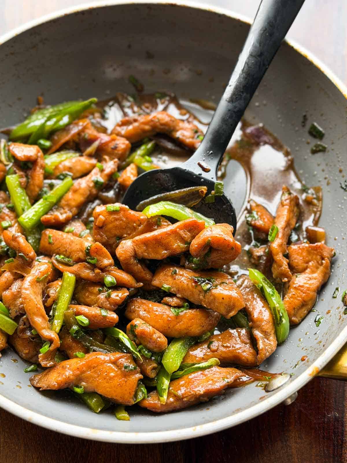soy sauce chicken in the frying pan with ladle